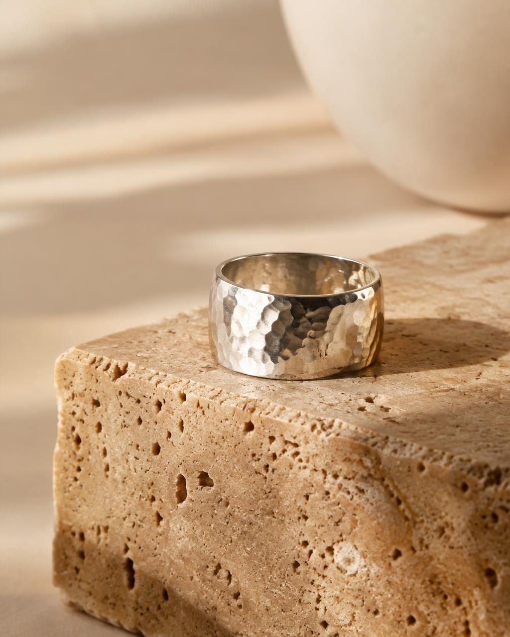 Wide hammered sterling silver ring on dark stone